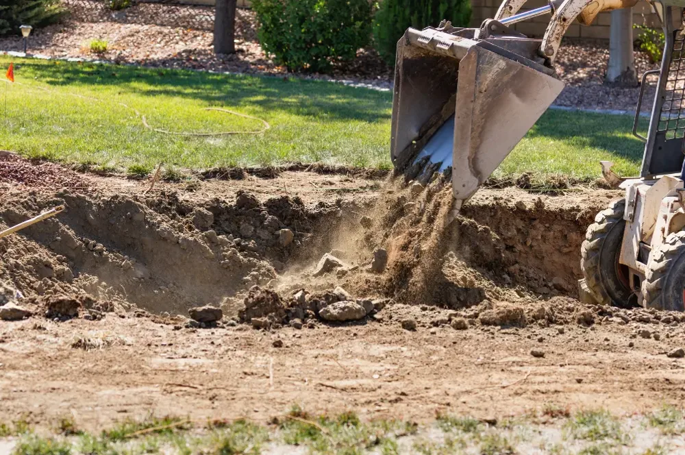 Excavation and grading work in a residential yard